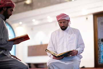 Image showing two muslim people in mosque reading quran together concept of islamic education