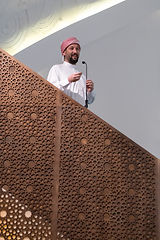 Image showing Muslims young arabic Imam has a speech on friday afternoon prayer in mosque.