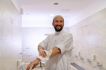 Image showing a portrait of a man in abdesthana using a towel