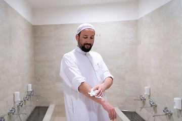 Image showing a portrait of a man in abdesthana using a towel