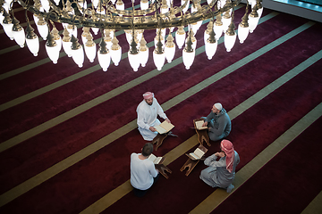 Image showing muslim people in mosque reading quran together