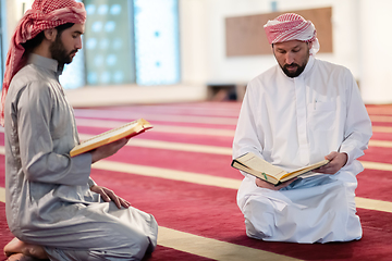 Image showing two muslim people in mosque reading quran together concept of islamic education