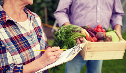 Image showing senior couple with box of vegetables at farm