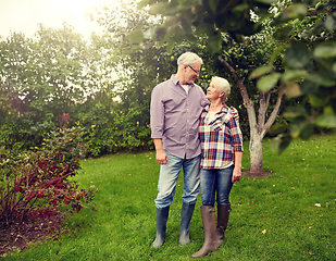 Image showing happy senior couple hugging at summer garden