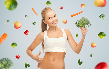 Image showing happy smiling young woman with broccoli