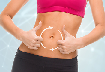 Image showing close up of woman showing tummy and thumbs up