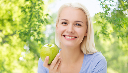 Image showing happy woman with green apple