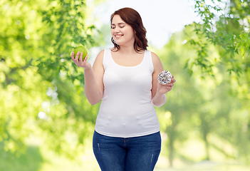 Image showing plus size woman choosing between apple and donut