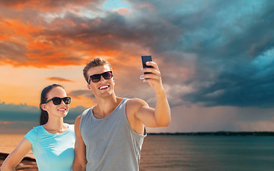 Image showing couple taking selfie by smartphone on beach