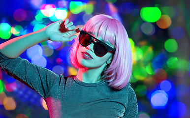 Image showing happy woman in pink wig and black sunglasses