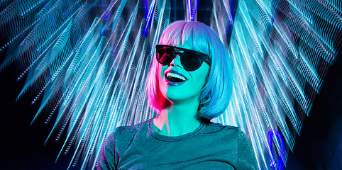 Image showing happy woman in pink wig and black sunglasses