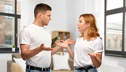 Image showing unhappy couple having argument at messy home