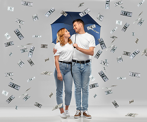 Image showing happy couple with umbrella standing money rain