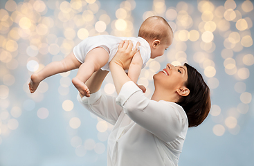 Image showing happy middle-aged mother with little baby daughter