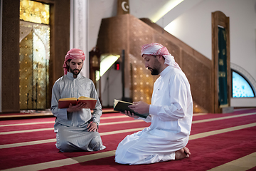 Image showing two muslim people in mosque reading quran together concept of islamic education