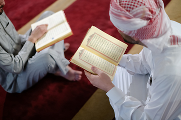 Image showing two muslim people in mosque reading quran together concept of islamic education