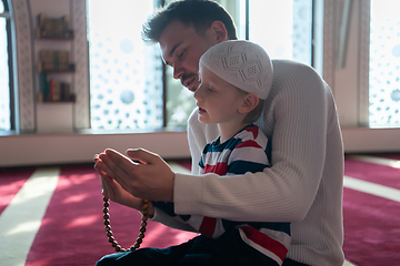 Image showing muslim prayer father and son in mosque prayingtogether