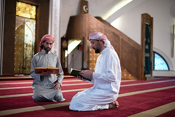 Image showing two muslim people in mosque reading quran together concept of islamic education