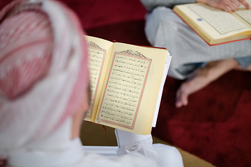 Image showing two muslim people in mosque reading quran together concept of islamic education