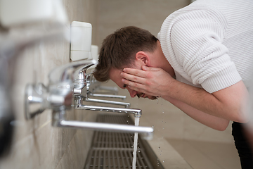 Image showing A Muslim takes ablution for prayer. Islamic religious rite