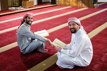 Image showing two muslim people in mosque reading quran together concept of islamic education