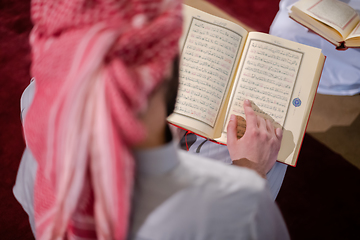 Image showing two muslim people in mosque reading quran together concept of islamic education
