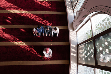 Image showing group of muslim people praying namaz in mosque.