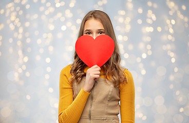 Image showing smiling teenage girl hiding over red heart