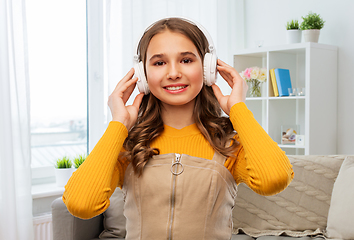 Image showing teen girl in headphones listens to music at home