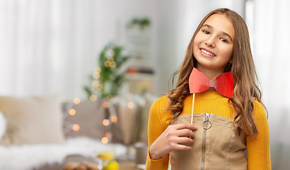 Image showing happy teenage girl with red bowtie party accessory