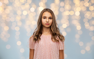 Image showing teenage girl in party dress over festive lights
