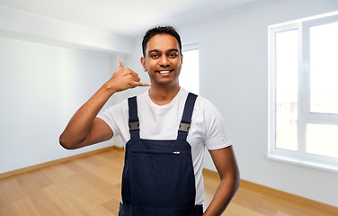 Image showing builder making phone call gesture at new home