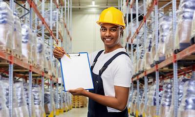 Image showing happy indian worker with clipboard at warehouse