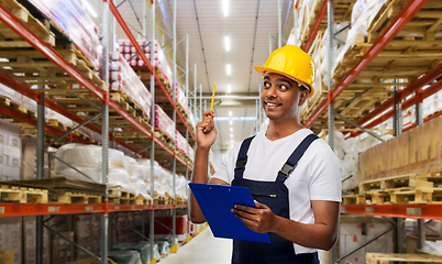 Image showing happy worker or loader with clipboard at warehouse