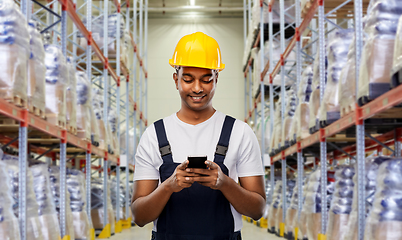 Image showing loader or worker with smartphone at warehouse