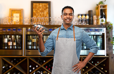 Image showing indian barman in apron with cocktail shaker at bar