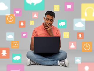 Image showing thinking indian man with laptop over app icons