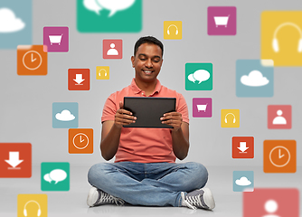 Image showing happy indian man with tablet pc over app icons