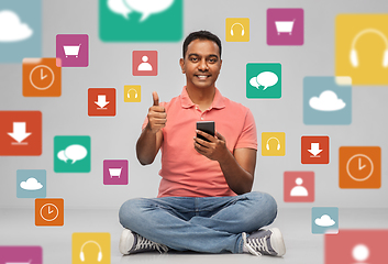 Image showing happy indian man with smartphone showing thumbs up