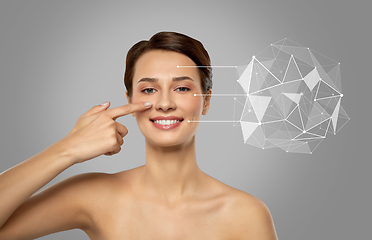 Image showing beautiful woman pointing finger to face skin