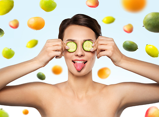 Image showing beautiful woman making eye mask of cucumbers