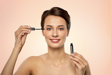 Image showing beautiful woman applying mascara