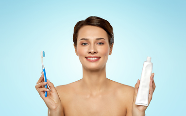 Image showing smiling woman with toothbrush cleaning teeth