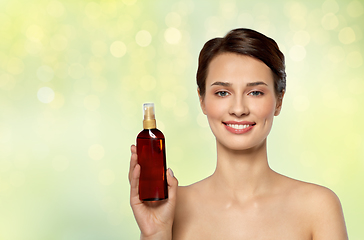 Image showing beautiful young woman with sun protective oil