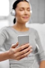 Image showing close up of woman with smartphone and headphones