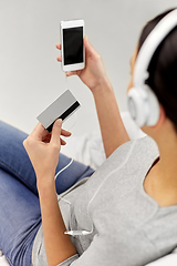 Image showing close up of woman with smartphone and headphones