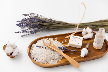 Image showing sea salt, lavender soap and serum on wooden tray