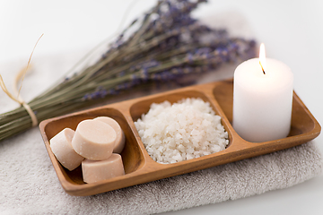 Image showing sea salt, soap, candle and lavender on bath towel