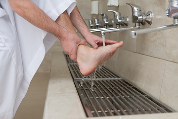 Image showing A Muslim takes ablution for prayer. Islamic religious rite