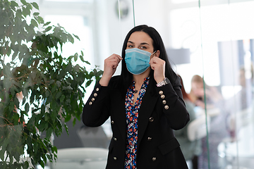 Image showing business woman portrait in medical protective mask